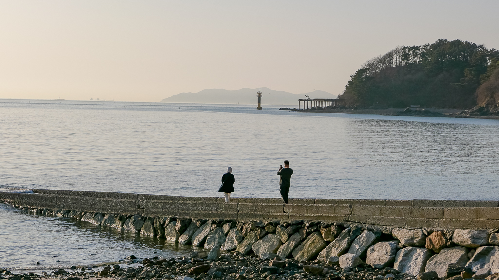 a couple taking photos together showing relationship context in korean culture